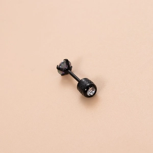 Macro shot of black stainless steel cartilage stud with rainbow zircon and textured grip