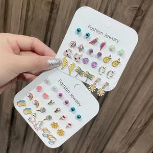 Detailed set of butterfly, unicorn and rainbow colorful stud earrings on card