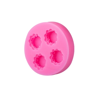 Pink silicone mold with four gear-shaped cavities for mini cheese and cookie decorations