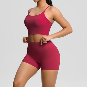 Detail of wine red brushed yoga set featuring cross-back bra and high-waist fitness shorts