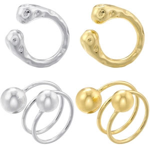 Detailed view of hammered gold and silver rings with spherical ball accents