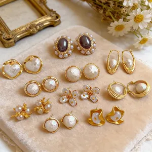 Vintage gold plated multi-layer floral and pearl earrings set on velvet display