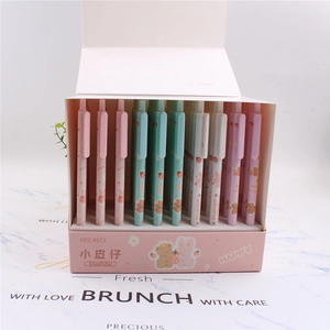 Close-up of cute cartoon mechanical pens in a pink display box on marble pattern background