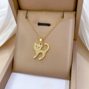 Detailed macro view of a gold-plated cat pendant necklace with pavé-set sparkling crystals