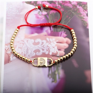 Adjustable red rope bracelet with gold beads and a sparkling zircon heart lock pendant