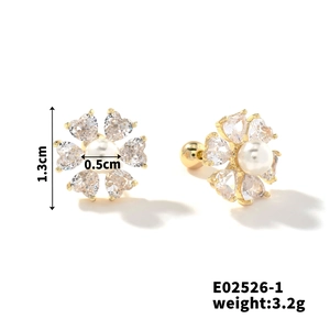 Detail view of 1.3cm gold floral stud earrings with white pearl and heart zirconia