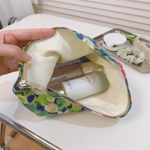 Interior view of floral canvas makeup bag showing spacious storage for skincare bottles