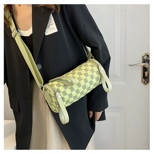 Checkered cylinder crossbody bag in mint green with wide strap and pleated texture