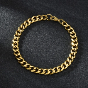 Macro shot of gold-plated titanium steel Cuban link bracelet with lobster clasp detail