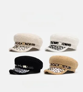Detail of four faux lamb wool military caps with leopard print brims and M letter metal