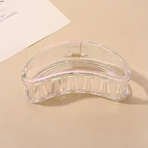 Macro shot of large iridescent aurora hair claw clip with a glossy translucent finish