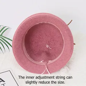 Pink knitted bucket hat for women featuring warm lining and adjustable inner drawstring