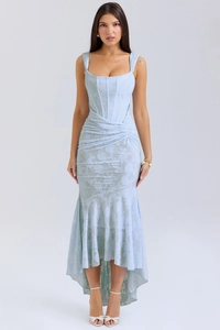 Close-up of light blue corset dress showing intricate jacquard texture and fishtail hem