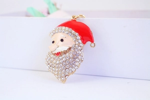 Close-up of Santa Claus keychain with sparkling rhinestones and red enamel details