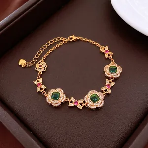 24K gold plated flower pendant bracelet with green square gems and ruby accents
