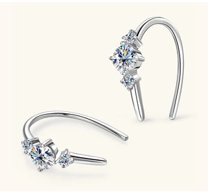 Macro detail of silver S925 earrings with three shimmering moissanite stones