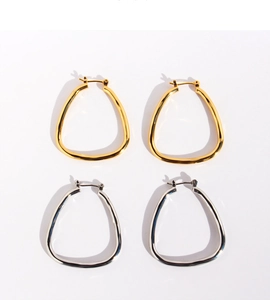 Detailed close-up of geometric square gold and silver hoop earrings on white background