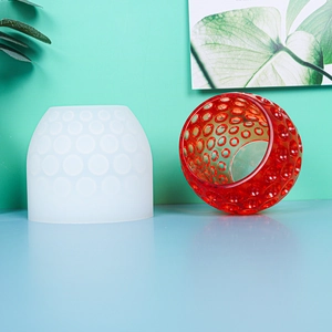 Macro detail of sphere silicone mold and a red textured resin candle holder craft