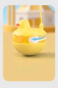 Close-up of yellow duck tumbler cat toy featuring dual spinning balls for interactive play
