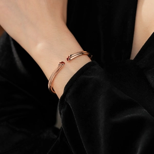 Detail view of rose gold gourd open bangle on model wrist with minimalist metal finish