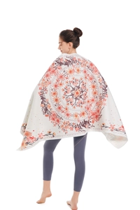 Detailed pattern of bohemian mandala microfiber beach towel worn as a wrap shawl