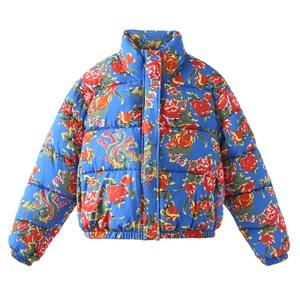 Detail of vibrant blue jacket with traditional dragon and floral patterns and high collar