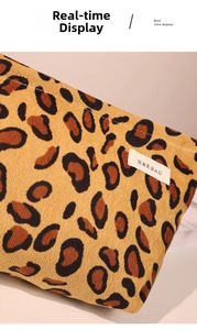 Close-up of leopard print corduroy makeup bag texture and H&R BAG woven label