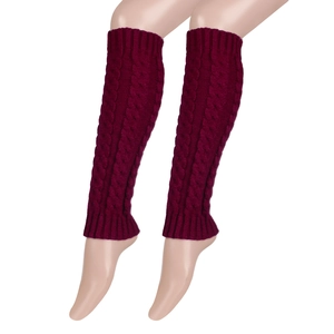 Close-up of chunky knit leg warmers in burgundy with twisted cable patterns and ribbed cuffs