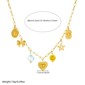 Collier à grosse chaîne dorée avec pendentifs cœur, smiley et cristal sur fond blanc