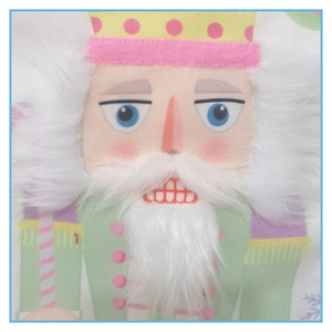 Close-up of nutcracker Christmas stocking with pink faux fur and detailed fabric texture