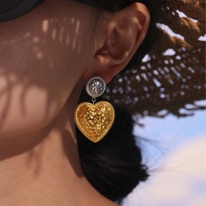 Two-tone textured heart dangle earrings in gold and silver finish with hammer pattern