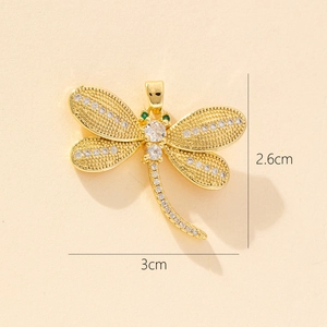 Detailed size view of a golden dragonfly pendant with sparkling white and green zircons