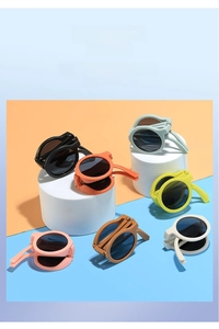 Foldable round frame children's sunglasses shown in seven vibrant colors for sun protection