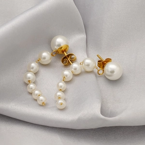 Elegant 18k gold plated stainless steel pearl tassel earrings on grey silk fabric