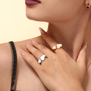 Double heart ring set with white mother of pearl inlay on model's hand in natural lighting