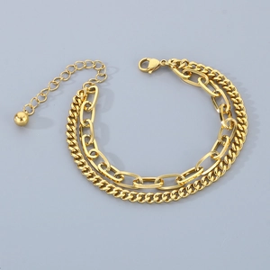 Detail of gold double-layer chain bracelet with paperclip links and lobster clasp closure