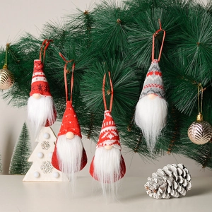 Set of 4 knitted Christmas gnomes hanging on a pine tree with festive ornaments