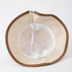 Detail of baby bucket hat featuring breathable mesh lining and adjustable windproof strap