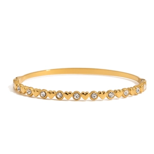 Elegant gold heart link bracelet with white zircon stones on a white background