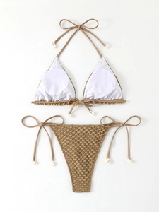 Detail of textured bikini fabric with white shell charms on adjustable tie strings