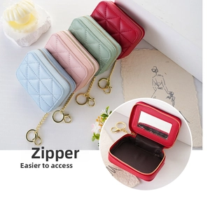 Detail view of mini quilted leather makeup bag with interior mirror and zip closure