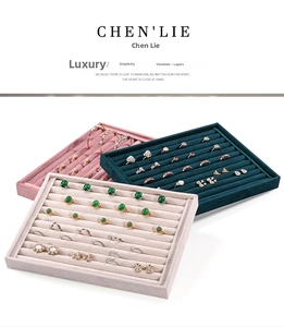 Three multi-slot velvet jewelry display trays for rings and earrings in pink, green, and beige