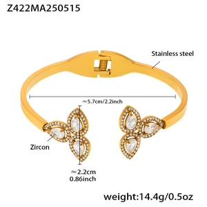 Macro detail of gold stainless steel bangle with zircon petals and 14.4g weight mark