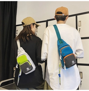 Detail of vibrant color-block crossbody chest bags in grey-green and blue-orange hues
