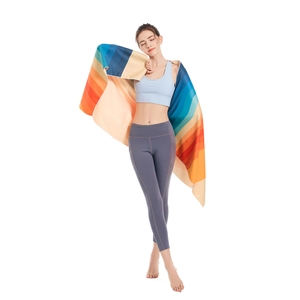 Microfiber rainbow striped beach towel draped over a female model shoulders
