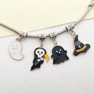 Detailed view of silver charm bracelet with Halloween ghost and Bad Witch hat pendants