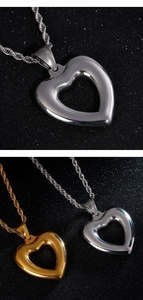 Detail of gold and silver hollow heart pendants with twisted rope chain necklaces