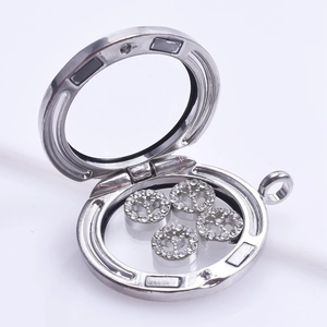 Detailed view of a silver floating locket with sparkling rhinestone peace sign charms