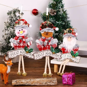 Detailed view of Christmas fabric ornaments with Feliz Navidad banners and metal bells