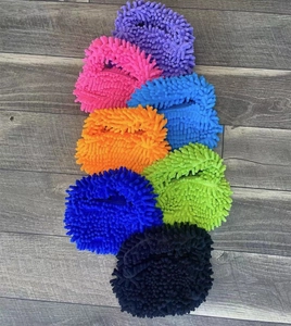Vibrant microfiber chenille mop covers in seven colors stacked on a grey wood floor